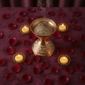 Top-down flat lay view of luxury antique brass Oud and Bakhoor burner on velvet fabric
